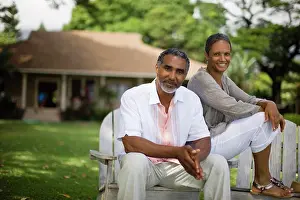50 To 55 Years Prints: Portrait of a couple smiling and sitting on chairs