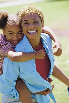 Purestock Prints: Portrait of a daughter riding piggyback on her mother