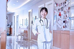 Proudly Prints: Portrait of doctor in hospital corridor looking at camera smiling