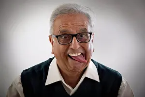 Sticking Out Tongue Prints: Portrait of an elderly man sticking his tongue out