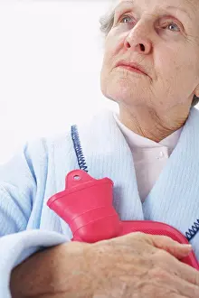 Depression Prints: Portrait of Elderly Woman Holding Hot Water Bottle