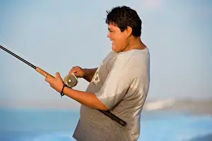 Seas Prints: Portrait of a fat boy fishing near the sea