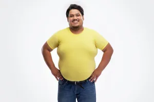 Overweight Prints: Portrait of a fat man smiling while placing hands on waist against plain background