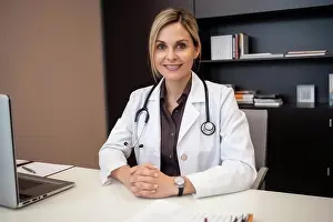 Physician Prints: Portrait of female caucasian doctor at her desk. Generative AI
