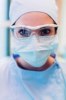 Assistant Prints: Portrait of female dentist, wearing surgical mask and protective eyewear, close-up