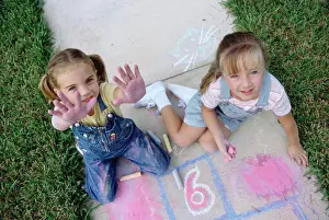 4 5 Years Prints: Portrait of two girls drawing on the ground with chalk