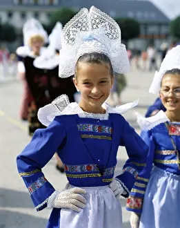 Arms Akimbo Prints: Portrait of two girls dressed in traditional clothing smiling, Brittany, France