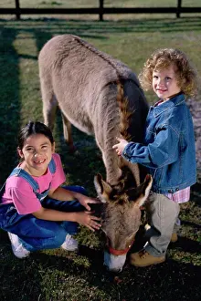 Crouch Prints: Portrait of two girls petting a donkey