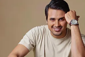 T Shirt Prints: Portrait of handsome young man smiling over colored background
