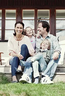 Vertically Prints: Portrait of happy family of four enjoying in yard