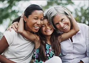 Asian And Indian Ethnicities Prints: Portrait of happy girl embracing mother and grandmother at yard