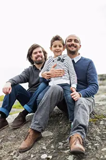 Midadult Men Prints: Portrait of happy male homosexual family relaxing on rock
