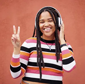 Audio Prints: Portrait, headphones and black woman with peace sign isolated on orange wall for gen z music or mental health
