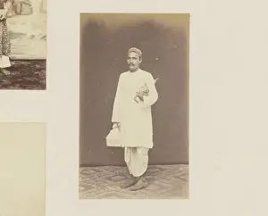 Portrait of an Indonesian man in a long robe with umbrella under the arm