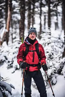 Hike Prints: portrait of male skier with red jacket in snow covered woods in Maine