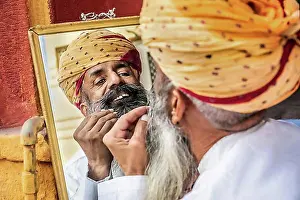 Beards Prints: Portrait of a man fixing his beard in a mirror, Jodhpur, Rajasthan, India, Asia
