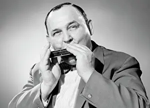 : Portrait of man playing on harmonica
