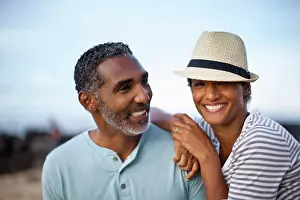 50 To 55 Years Prints: Portrait of mature couple lovingly sitting together