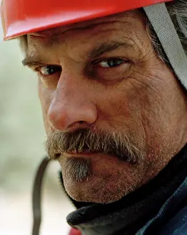 Out Door Prints: Portrait of a mature man wearing a hardhat