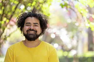 Individuality Prints: portrait of a Mexican man smiling with curly hair and beard