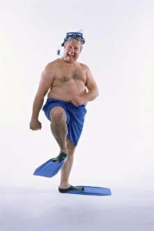 Diving Equipment Prints: Portrait of a mid adult man in shorts wearing flippers with a mask and a snorkel