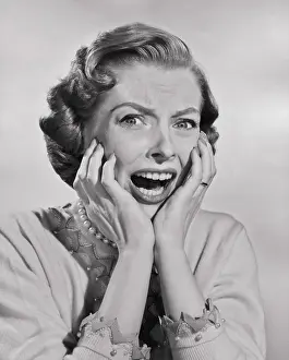 Sorrow Prints: Portrait of a mid adult woman screaming