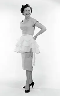 Medium Length Hair Prints: Portrait of mid adult woman trying on tutu
