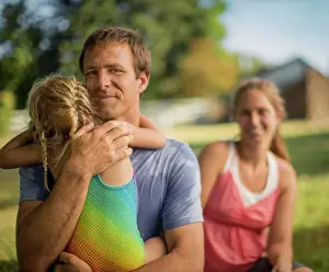 30 To 35 Years Prints: Portrait of a middle-aged father gently hugging his young daughter