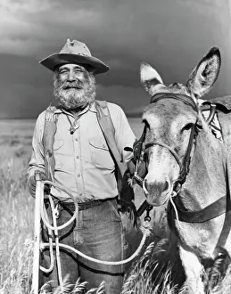 Adult Animal Prints: Portrait of a miner with his donkey