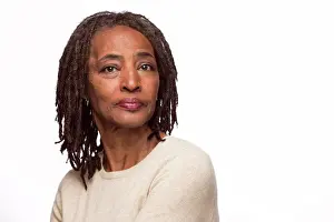 Senior Women Prints: Portrait of older black woman looking at camera over shoulder with straight face