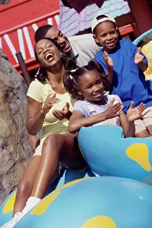 4 5 Years Prints: Portrait of parents and their two children in an amusement park