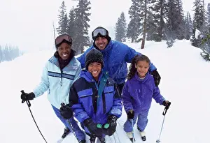 Father Prints: Portrait of parents standing with their two children in snow