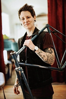 Top Section Prints: Portrait of pierced and tattooed woman with bicycle frame on her shoulder
