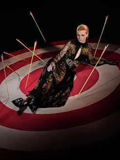 Redhead Prints: Portrait of a redhead woman on large hand painted Bulls-eye target with arrows