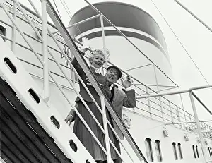 Senior Women Prints: Portrait of a senior couple waving from a ship