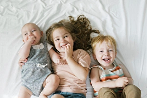 Preschool Age Prints: Portrait of siblings (6-11 months, 2-3) lying on bed