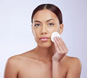 Pure Prints: Portrait, skincare and cotton pad with a woman in studio on a gray background for natural treatment or beauty