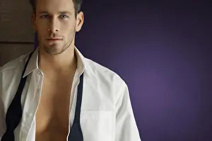 Bare Chest Prints: Portrait of a smart man wearing unbuttoned shirt over purple background
