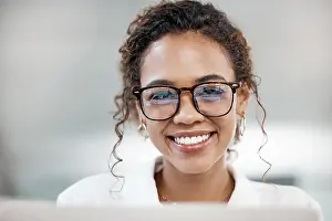 Agent Prints: Portrait, smile and business woman in glasses on laptop in office for software development in startup