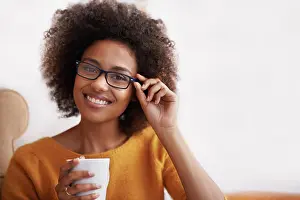 Wear Prints: Portrait, smile and glasses on woman in home lounge