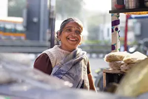 Facial Expression Prints: Portrait of a smiling female vendor at her roadside food stall