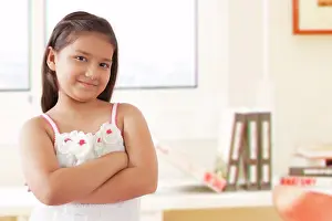 10 11 Years Prints: Portrait of smiling girl standing with arms crossed