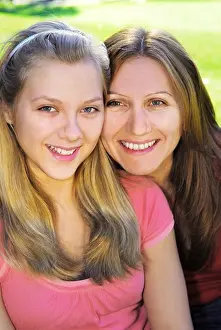 Parenting Prints: Portrait of a smiling mother and teenage daughter in summer park
