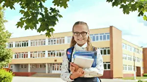 Student Prints: Portrait of smiling school girl child with backpack and books