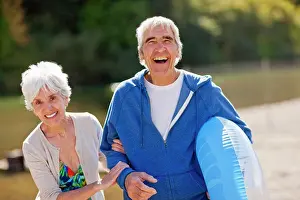 50 To 55 Years Prints: Portrait of a smiling senior couple having fun while on vacation together