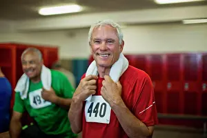 Halflength Prints: Portrait of a smiling senior man in a locker room