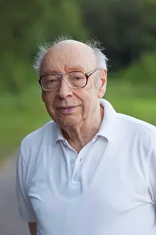 White Color Prints: Portrait of smiling senior man standing at park