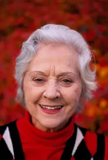Expressions Prints: Portrait of a smiling silver-haired senior woman wearing a red white and blue sweater