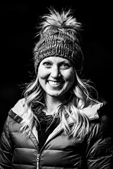 Facial Expression Prints: Portrait of smiling young woman in warm clothing against black background