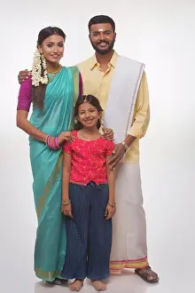 Father Prints: portrait of a south indian family smiling at the camera